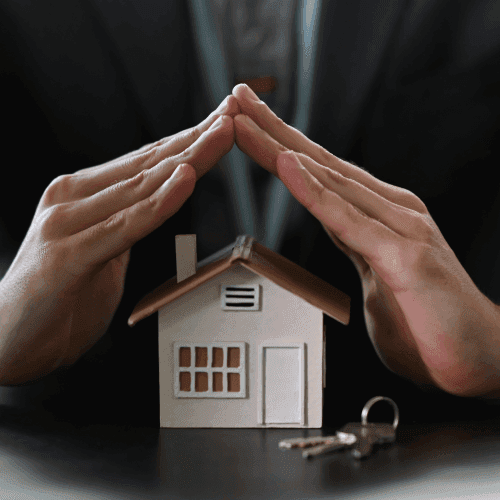 Hands over a model house