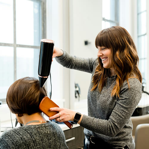 Hair dresser styling hair